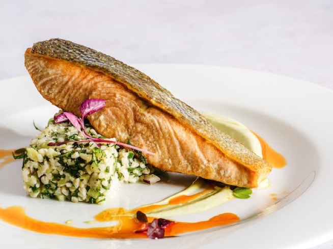 salmon filet on plate on bed of rice